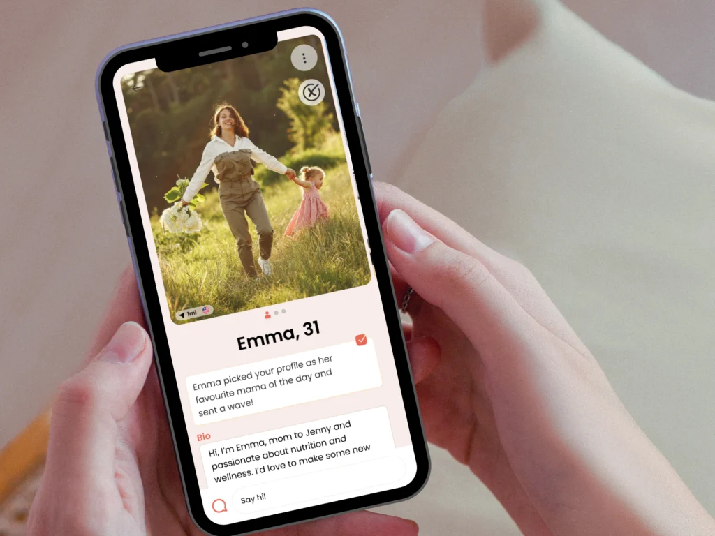 Phone showing a MamaMeet profile of Emma, 31, who sent a wave